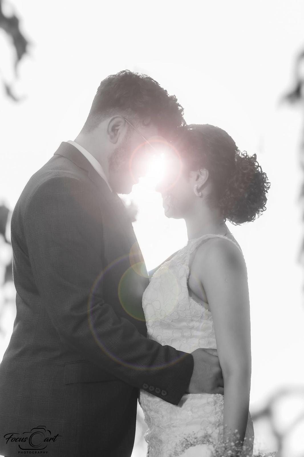 The couple silhouetted in soft evening light
